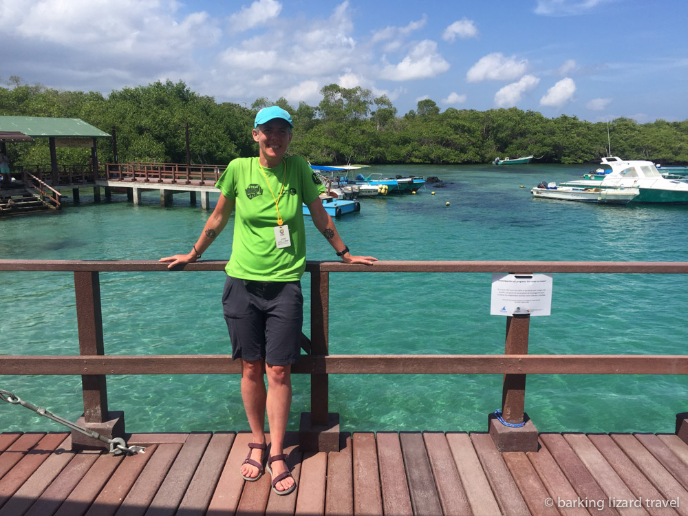 a photo of lydia standing on the boardwalk in puerto villamil harbour isabela