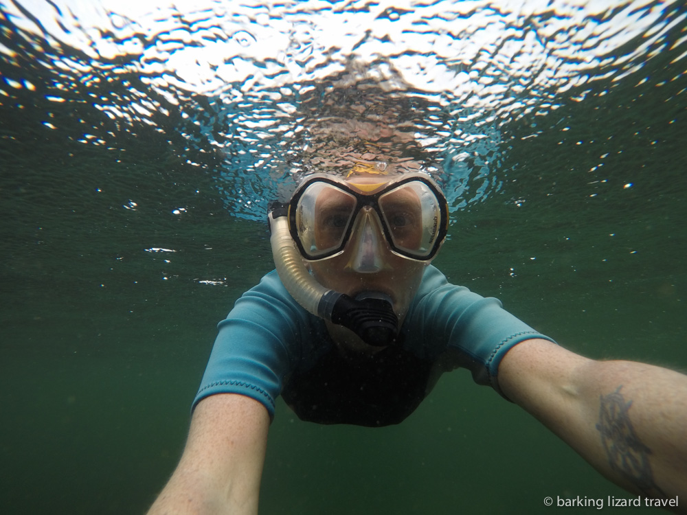 lydia snorkelling in the rain at los tuneles, galapagos islands