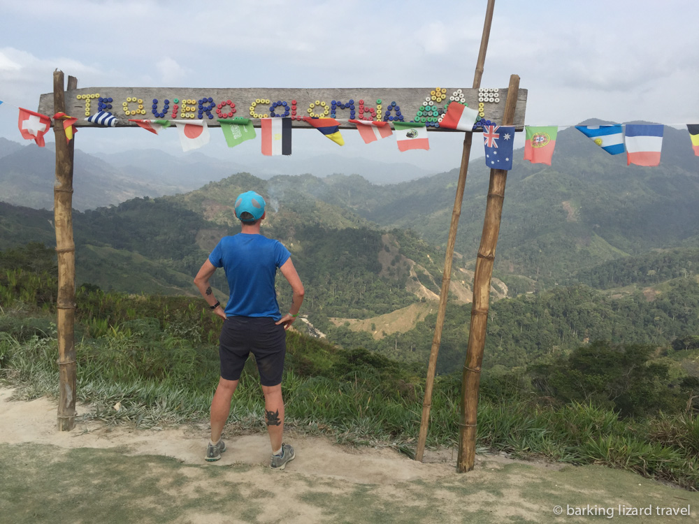 Lydia looking out at Sierra Nevade under an 'I love you Colombia' sign