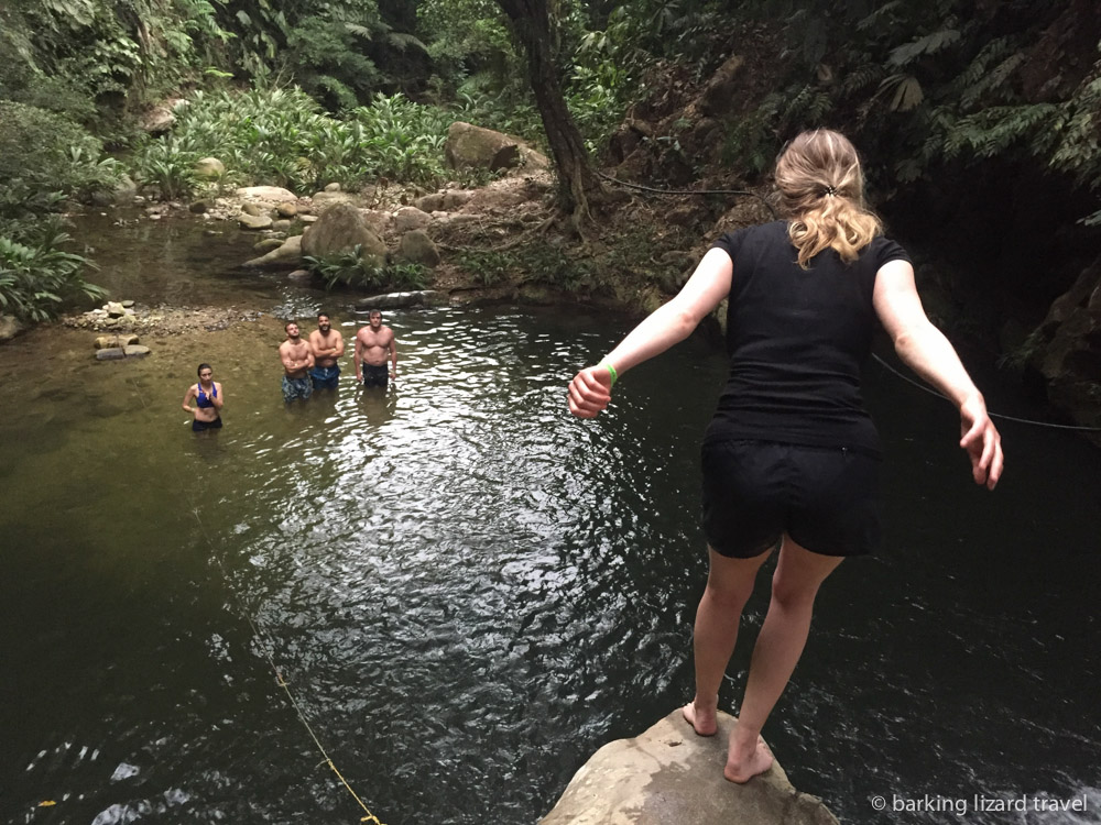 woman about to jump into a natural pool 
