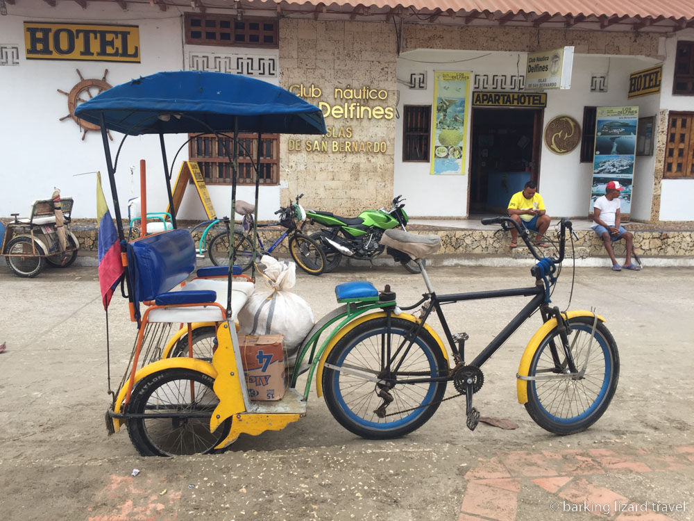 a photo of a bicitaxi, a bicycle taxi on a street in Tolú