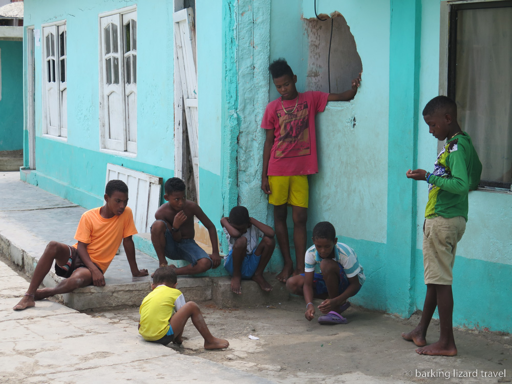 a photo of boys playing marbles on the street of Santa Cruz del Islote
