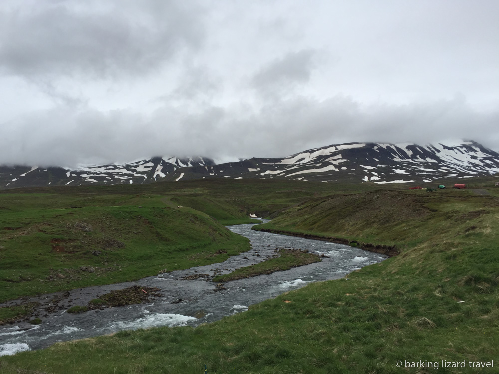 a photo of snow capped hills and river in Brunastadir  