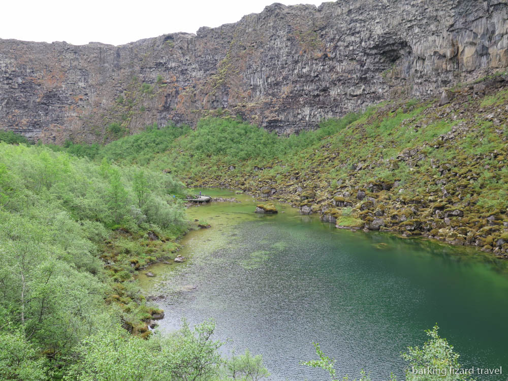 The Ásbyrgi canyon with a lake surrounded by green slopes