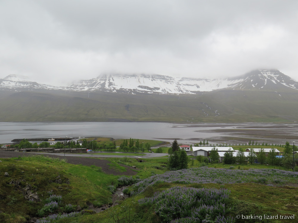 a photo of snow capped hills over the Eastfjords in Fáskrúdsfjördur