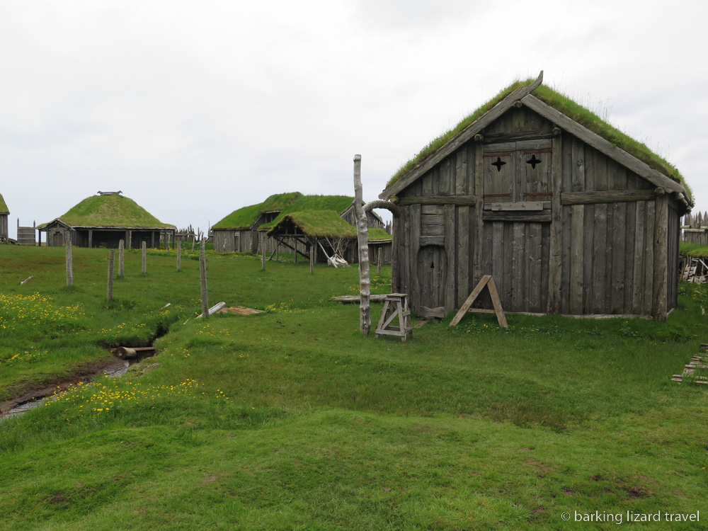 a photo of a wooden hut with a grass roof